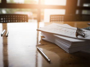 documents stacked on table