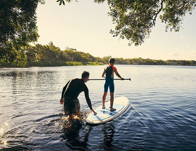 padding boarding on lake